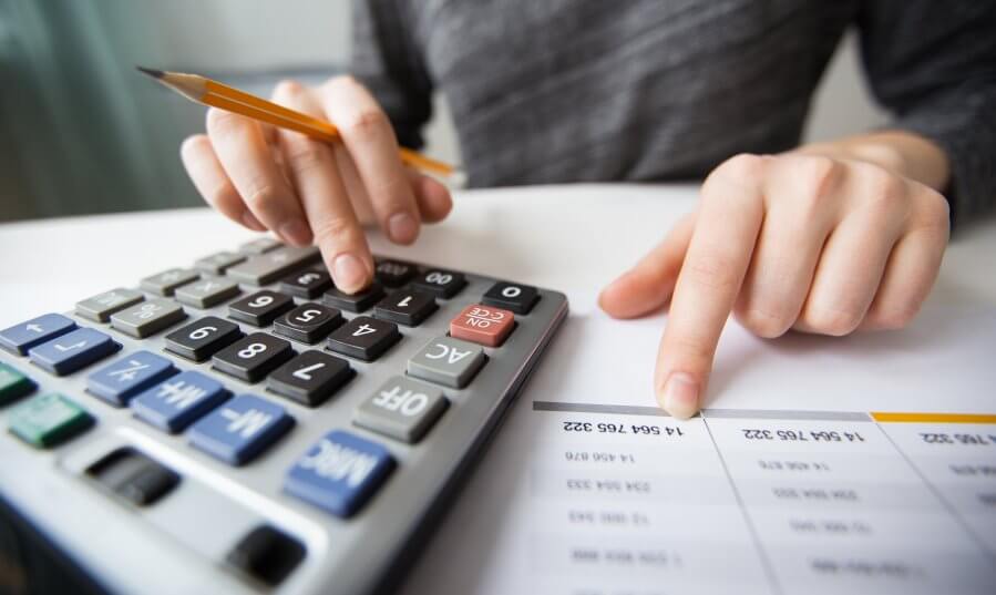 closeup accountant hands counting calculator